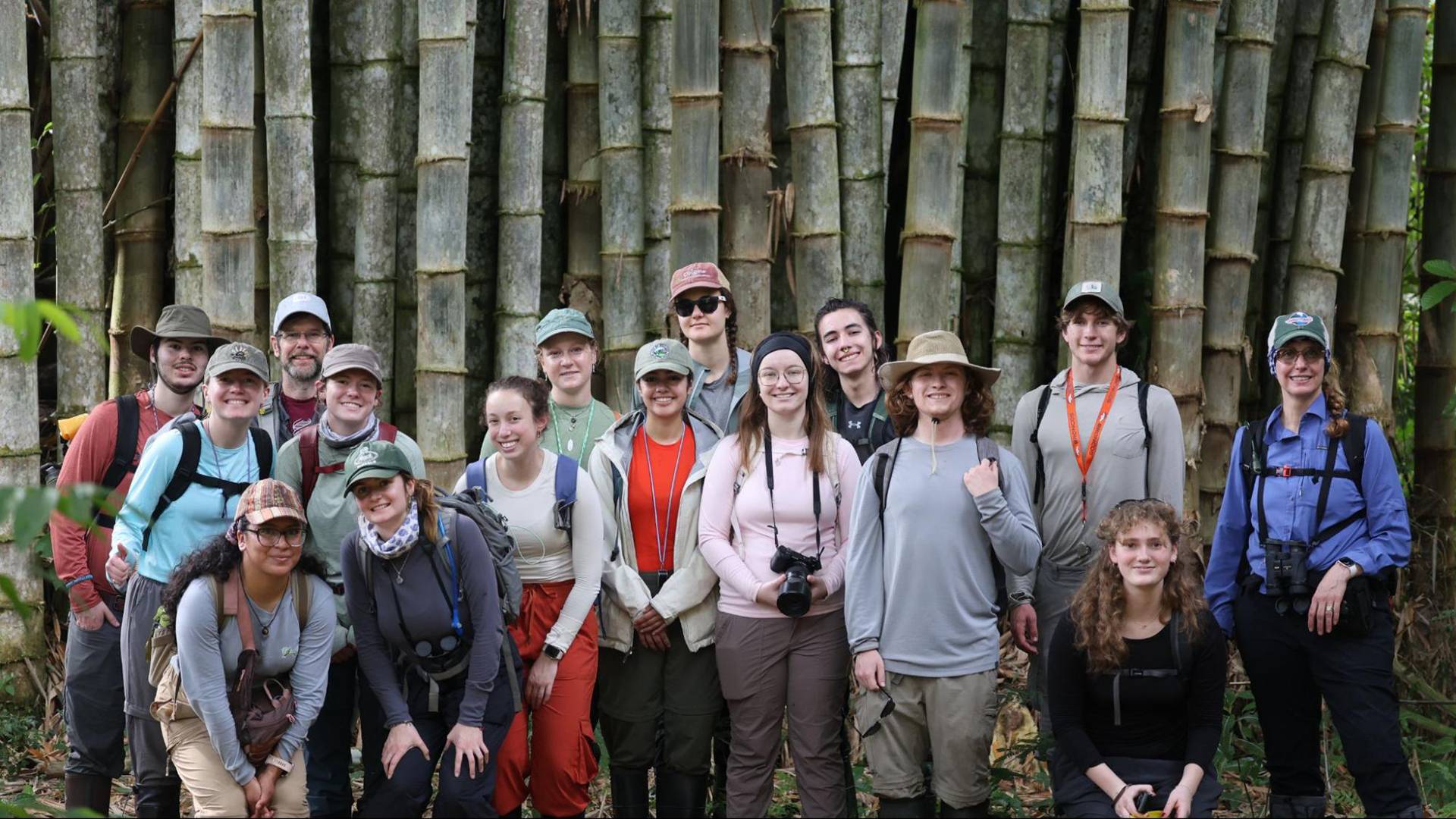 Colgate’s Tropical Ecology cohort pose for a group photo in front of thick bamboo stalks.