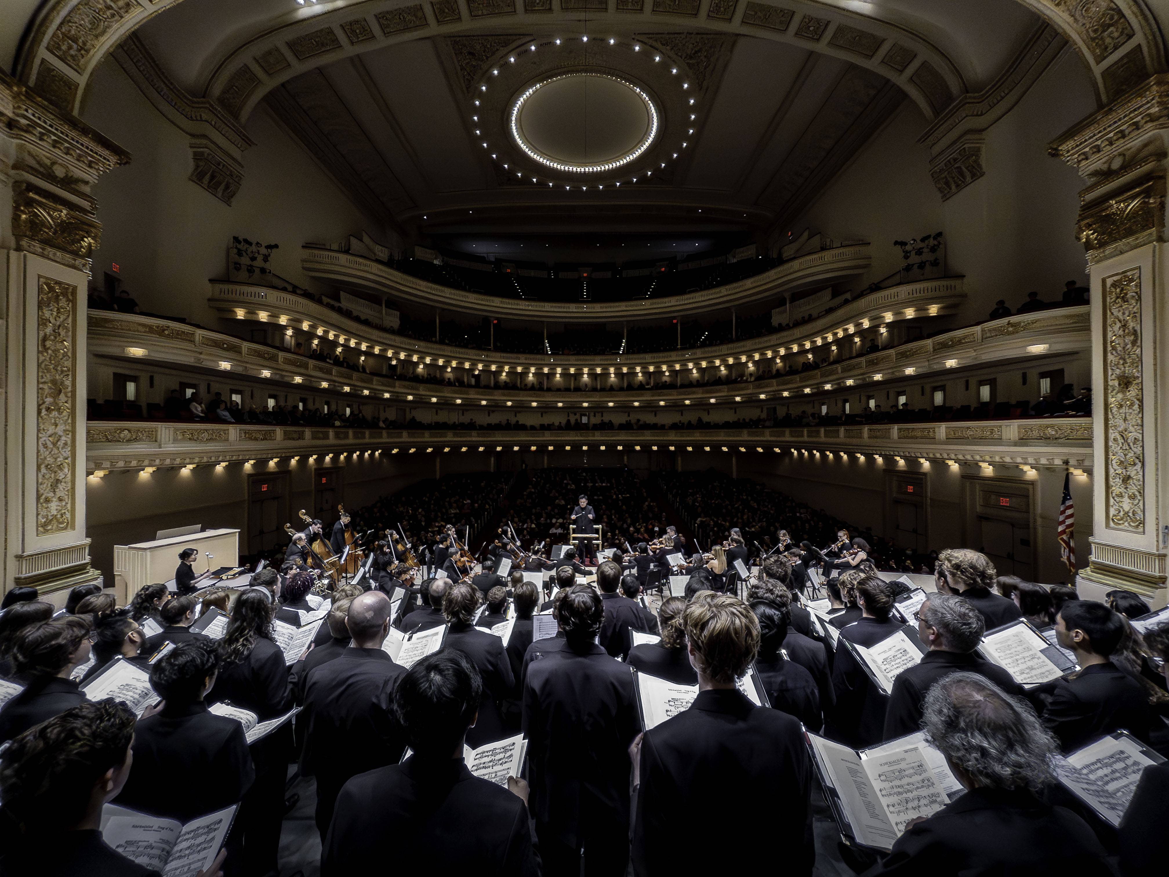 Colgate University Chorus and Hamilton College Choir look out at the audience of Carnegie Hall