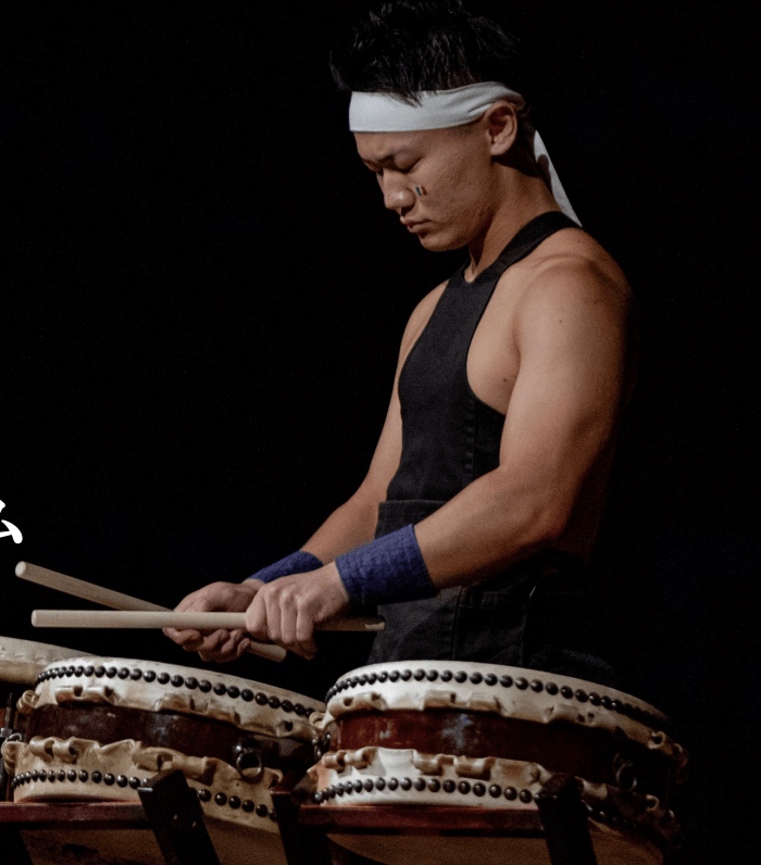 Japanese student playing taiko drums for guiding meditation