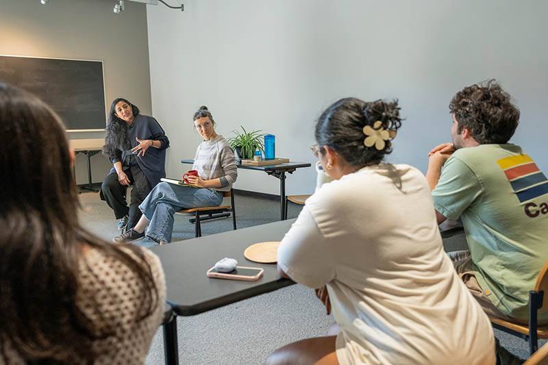 Artist Suchi Reddy speaks with a class