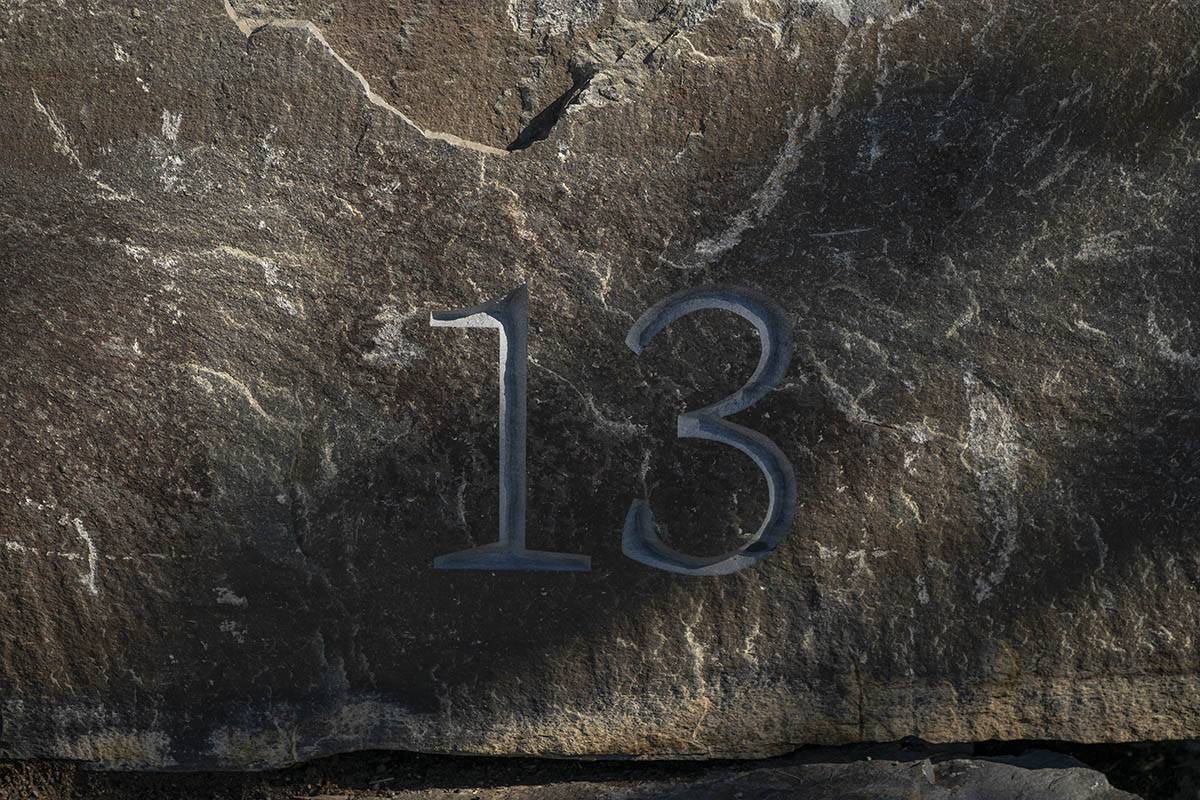 The number thirteen etched into a rock