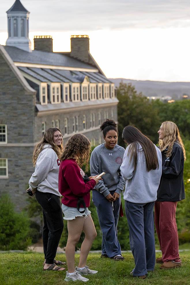 A group of five students talk