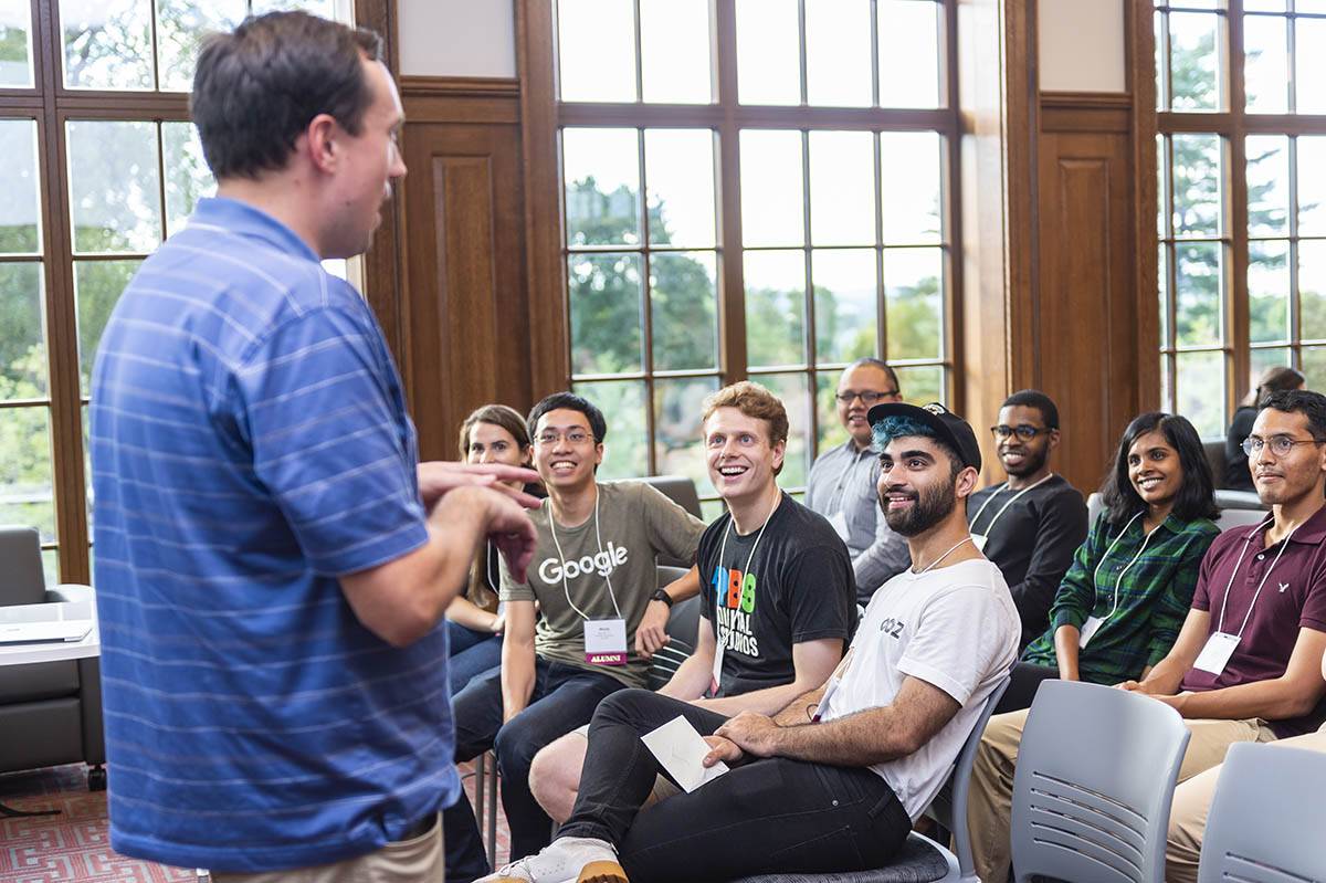 A presenter speaks to a room of students