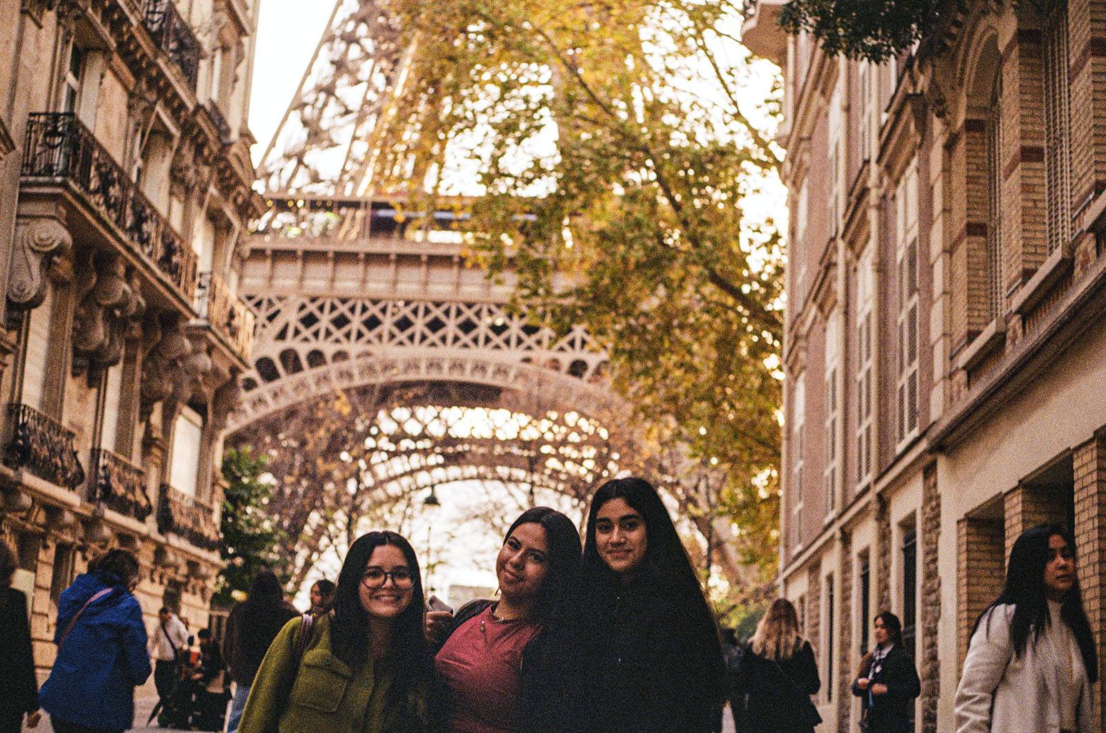 Three students pose in front of the Eiffel Tower