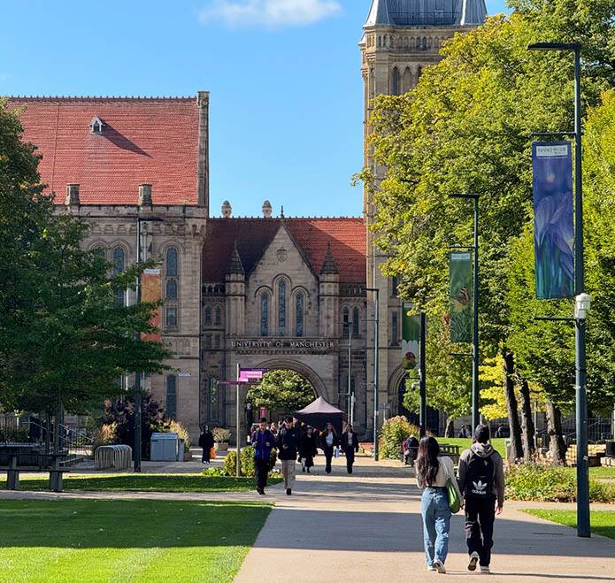 Students walk on the University of Manchester campus