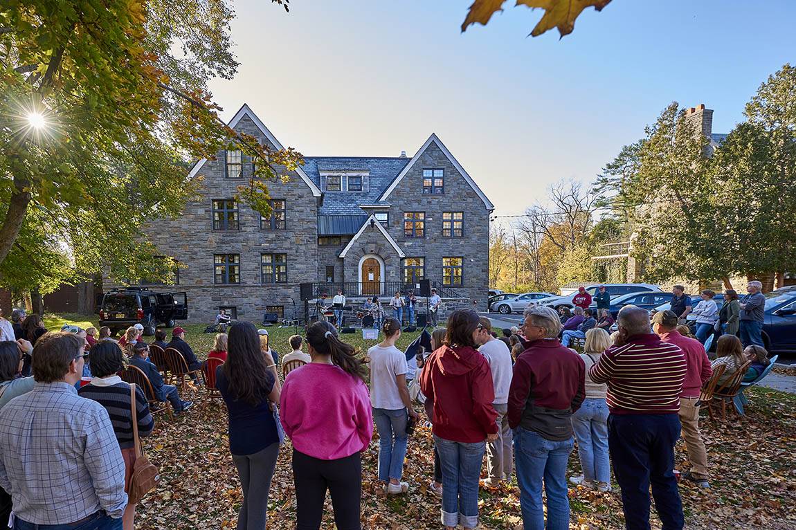 A band performs outside of a residential theme house