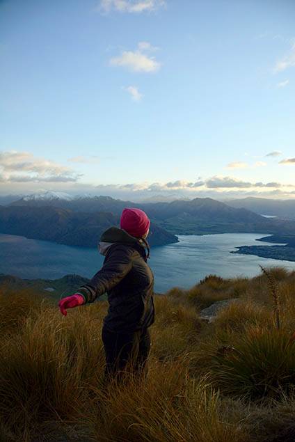 Student stands on grassy mountaintop