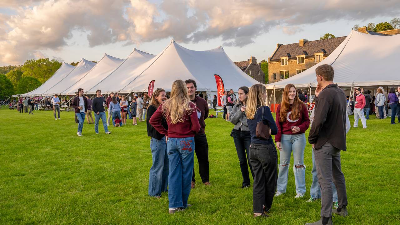 Alumni at reunion with tents
