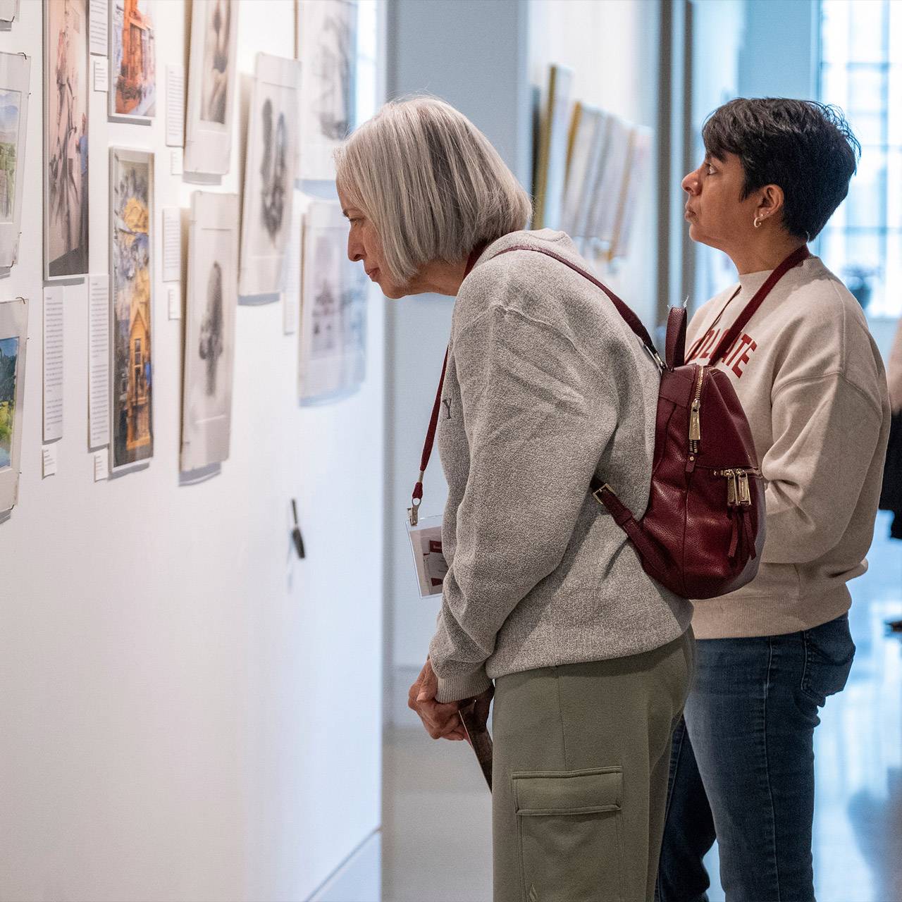Alumni at reunion viewing art
