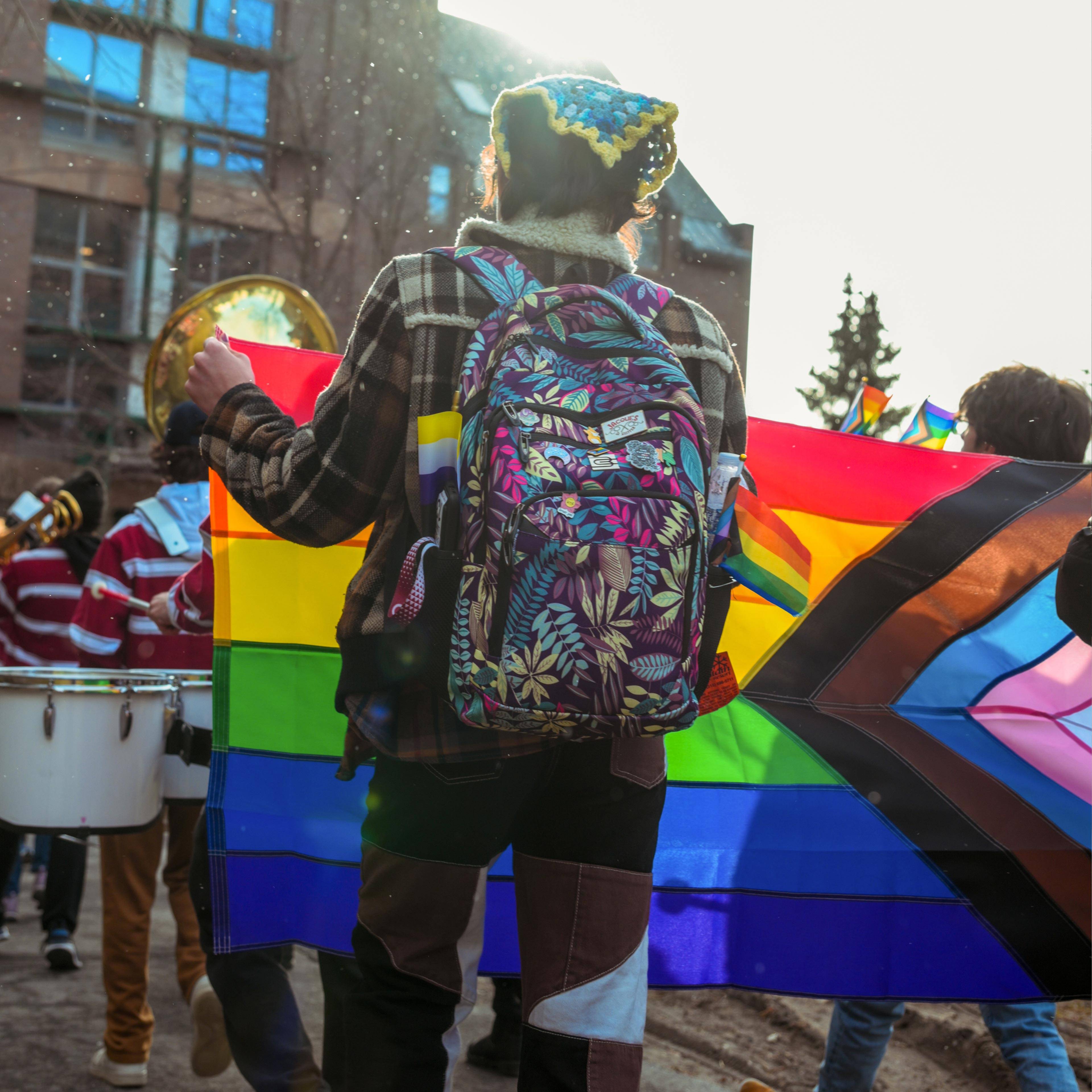Students marching with pride flag