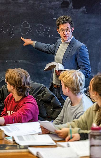 Daniel Tober points at a blackboard