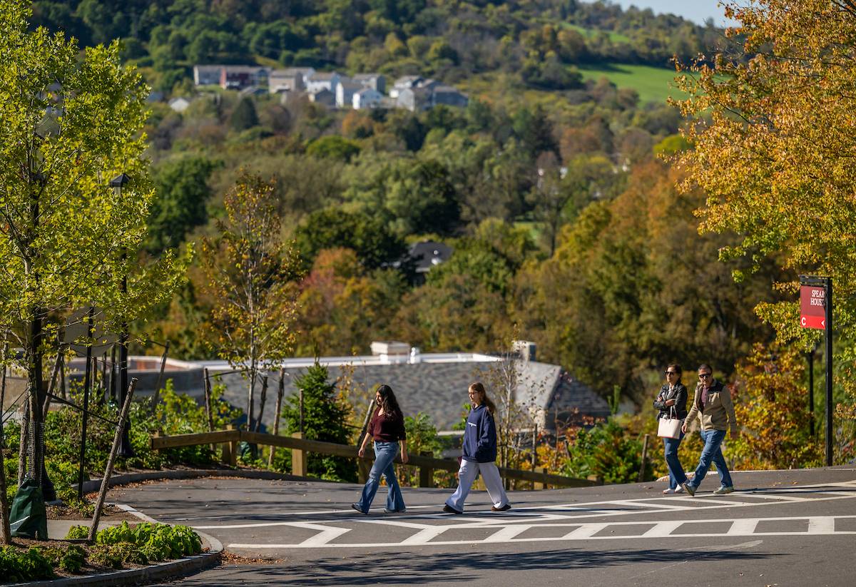 Family walks along beautifully landscaped Peters Glen on Colgate campus
