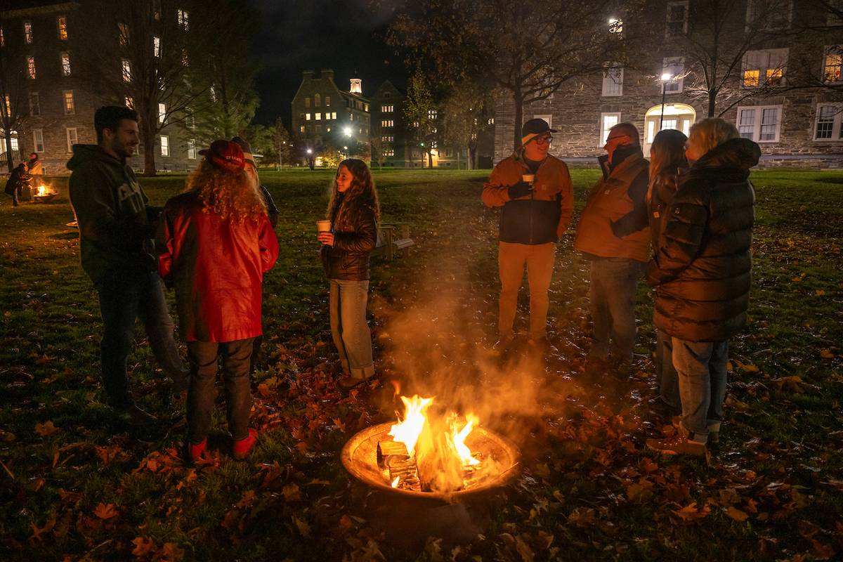 Families stand around bonfire on Colgate University campus 