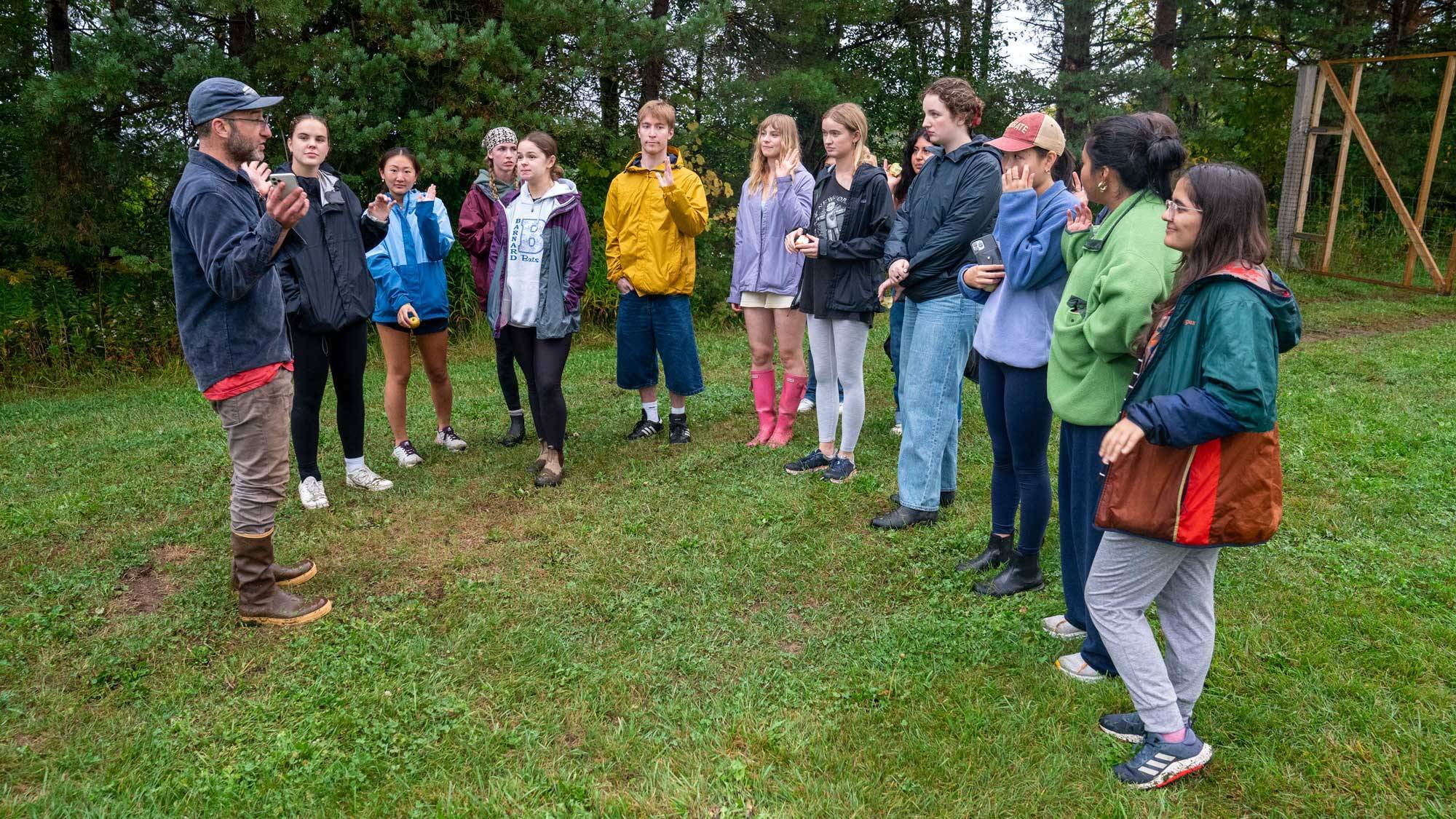 Prof. Stern stands with students outdoors