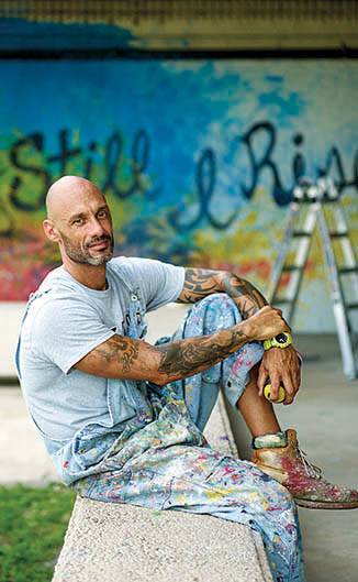 German DuBois near one of his murals