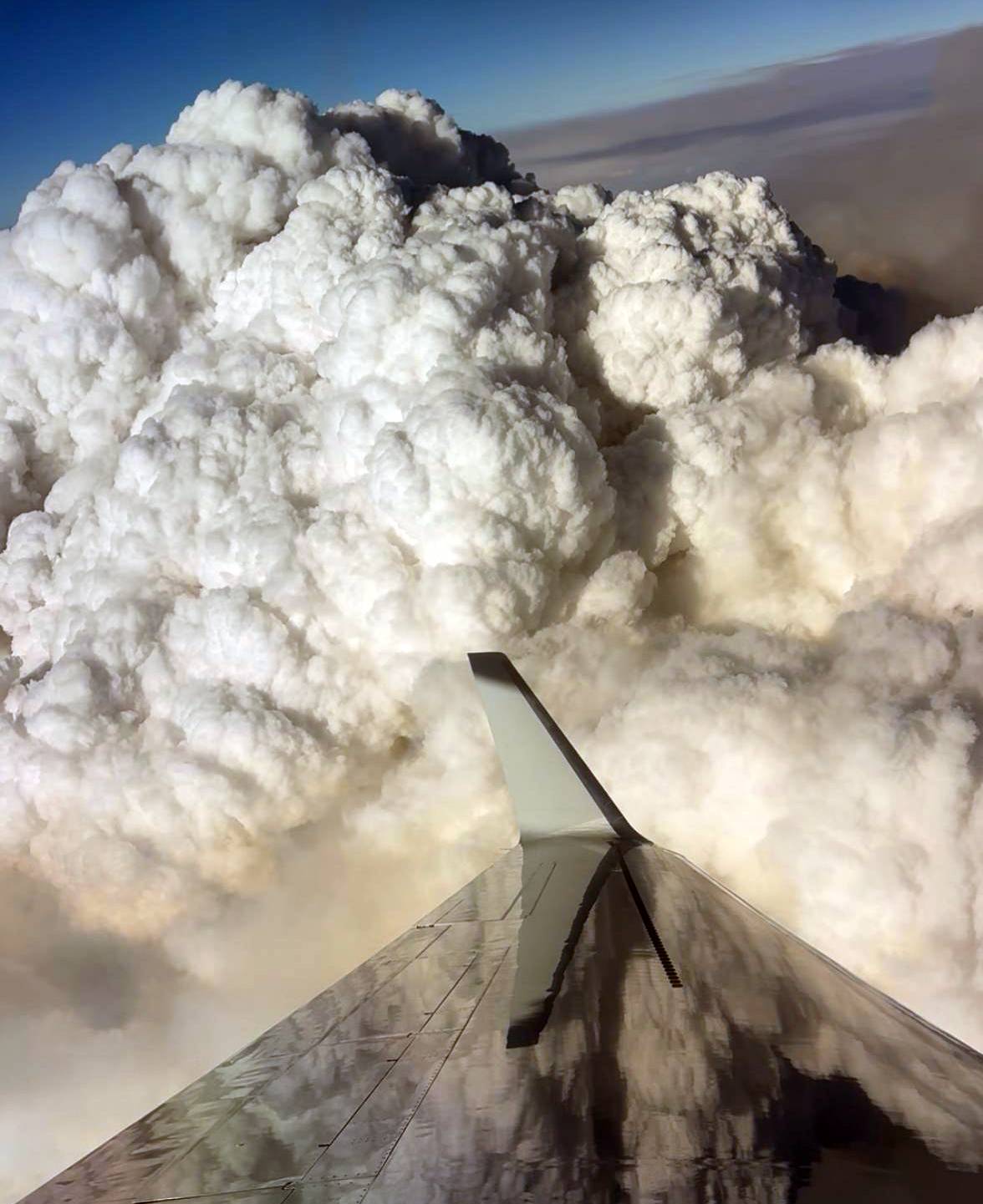 The wing of the plane as it orbits around a large pyrocumulus cloud associated with the Widemouth Fire in Utah