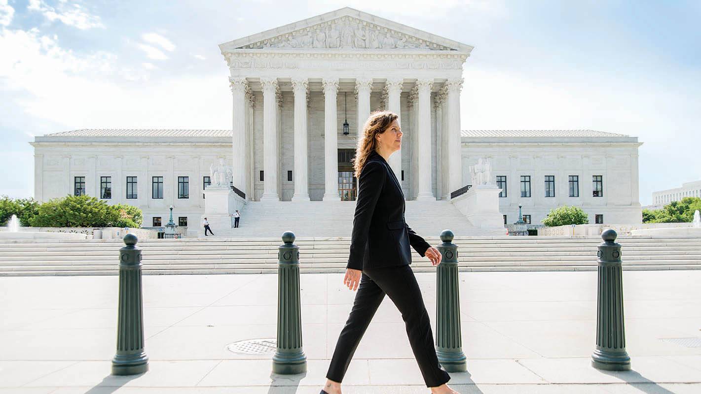 Katie Redford strides past a court house