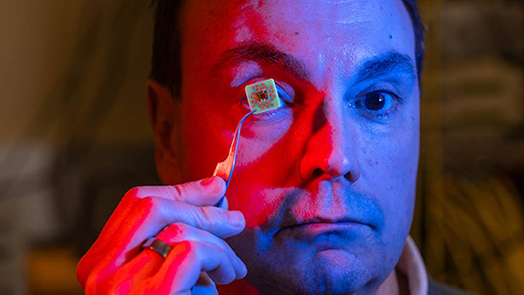 Ken Segall holds a computer chip up