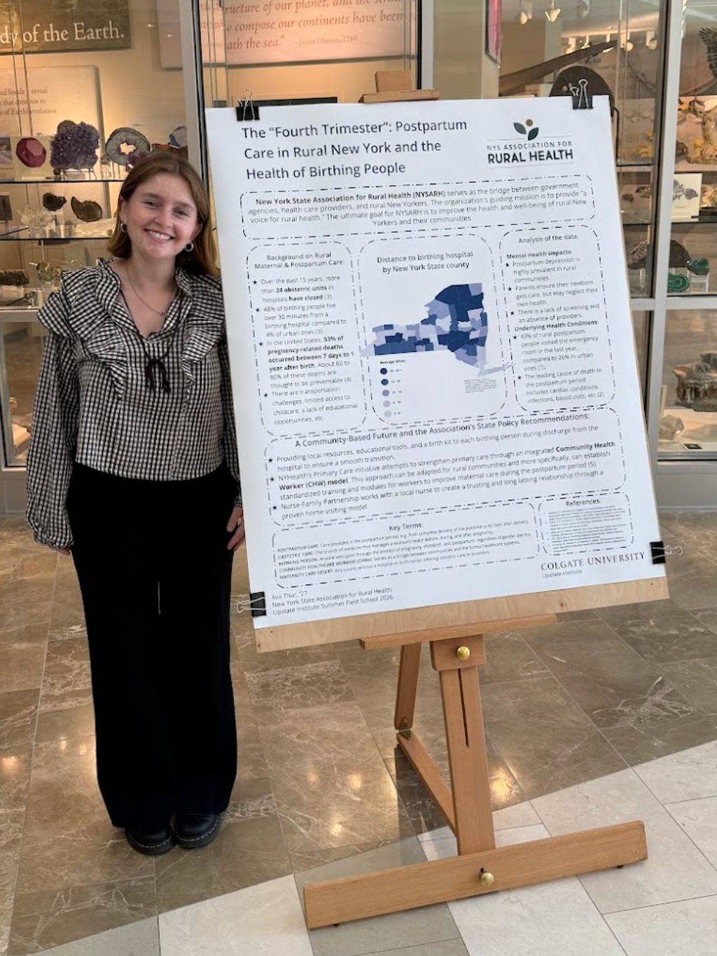 Ava Thur '27 poses with her 2026 Summer Field School research project poster from her work with New York State Association for Rural Health this summer during the Upstate Institute Summer Field School poster session in July. 