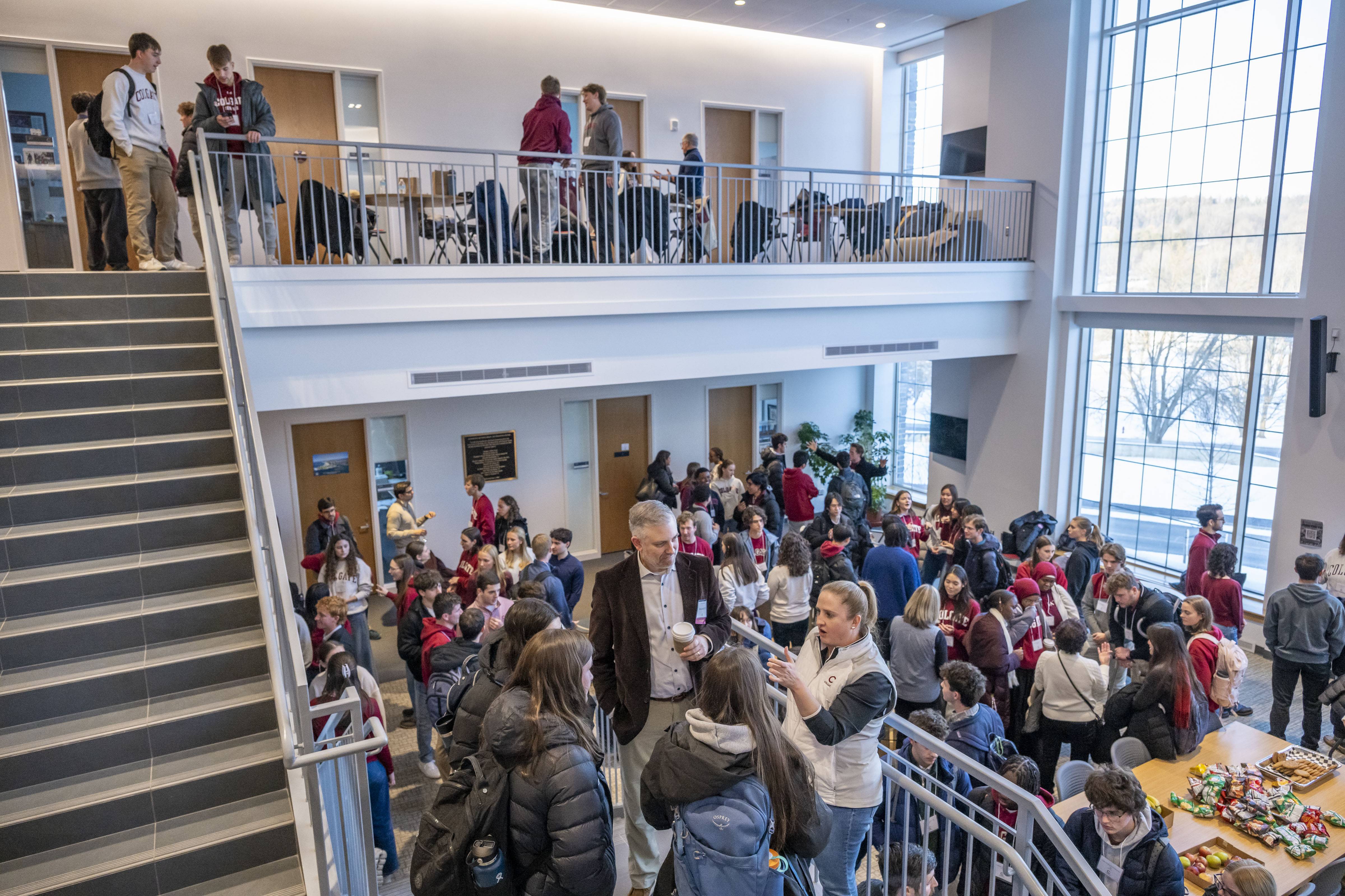 A group of people gather in an academic building.