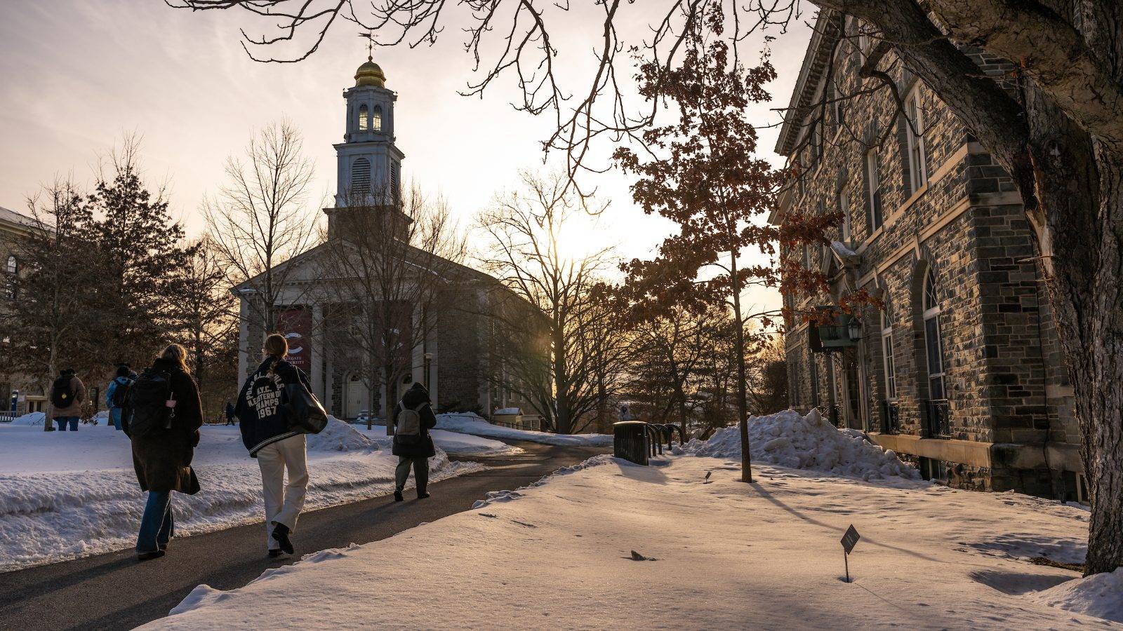 Students walk on the snow-covered quad near the Colgate Chapel.