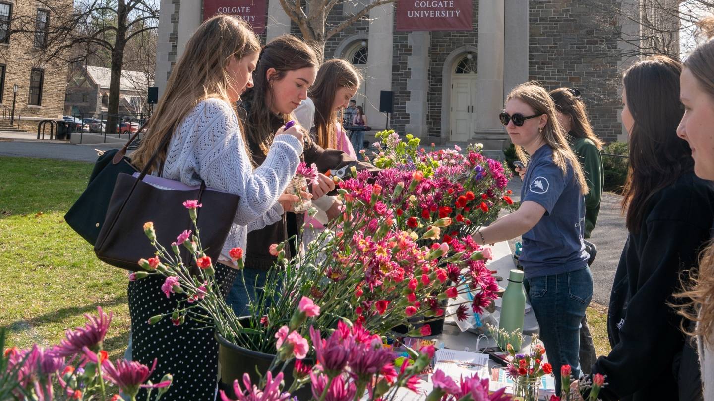 Students/Staff selling flowers on the Quad on 10 Days of Green kickoff.