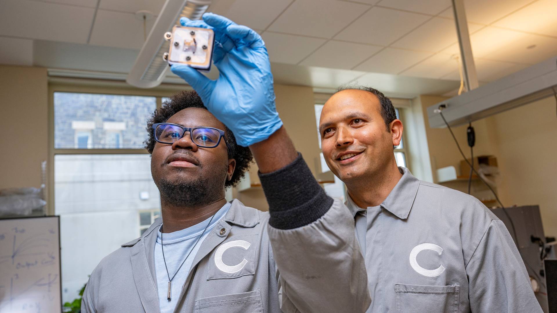 From left, Nathan Walsh ’28 and Assistant Professor of Physics Ramesh Adhikari work on a bio-based energy source (photos by Mark DiOrio)