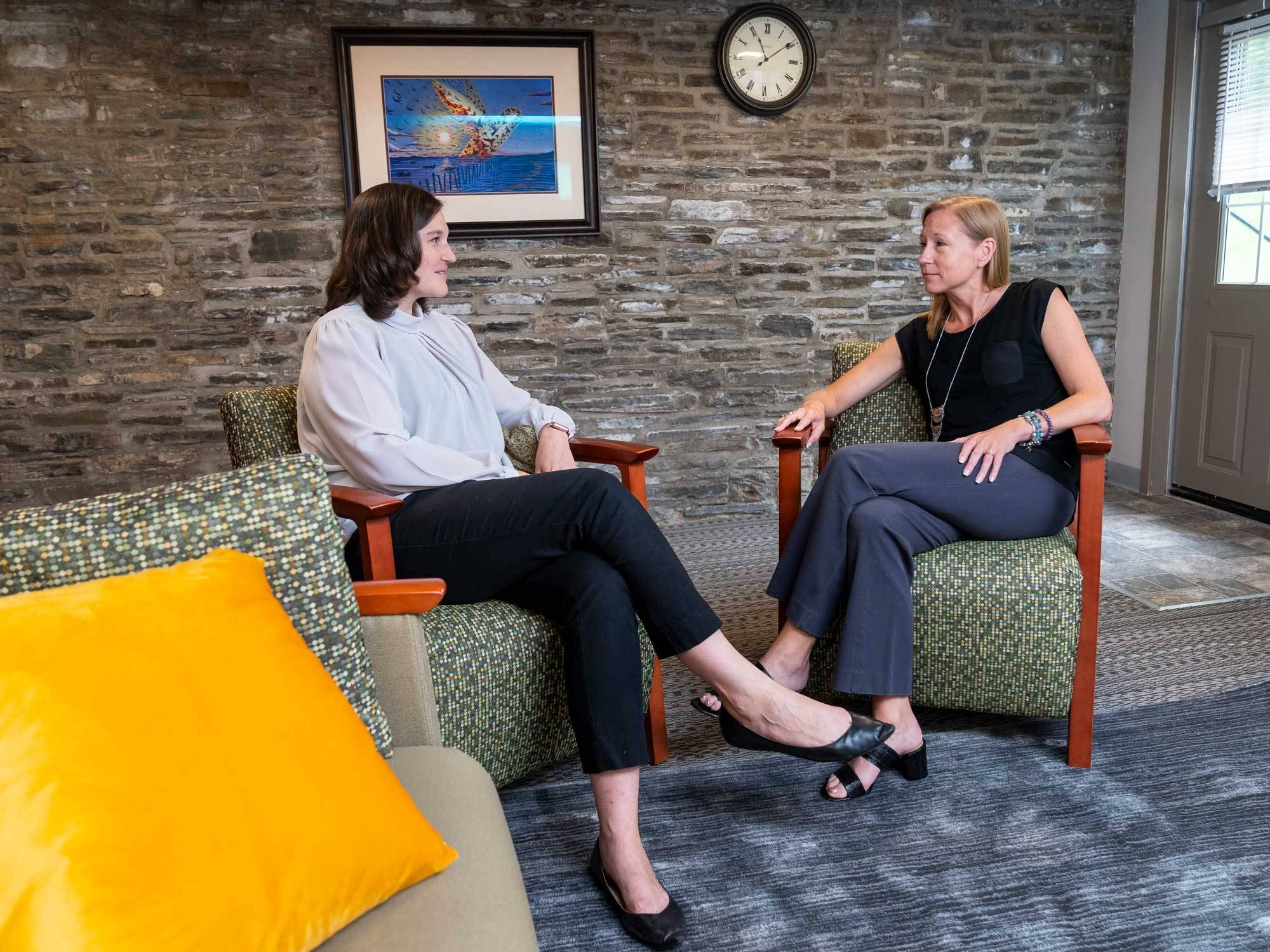 Niki Keating and Dawn LaFrance chat in one of the group therapy spaces in Conant House. 
