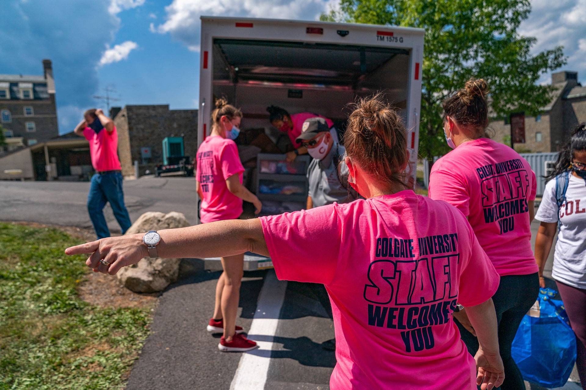 Staff in pink TShirts assist with first-year arrival 2020