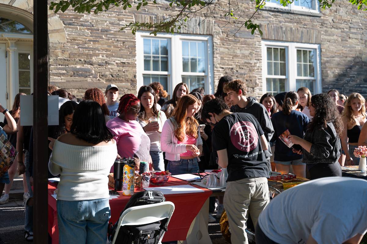 Students gather on campus a sunny day to sign up for organizations and clubs.