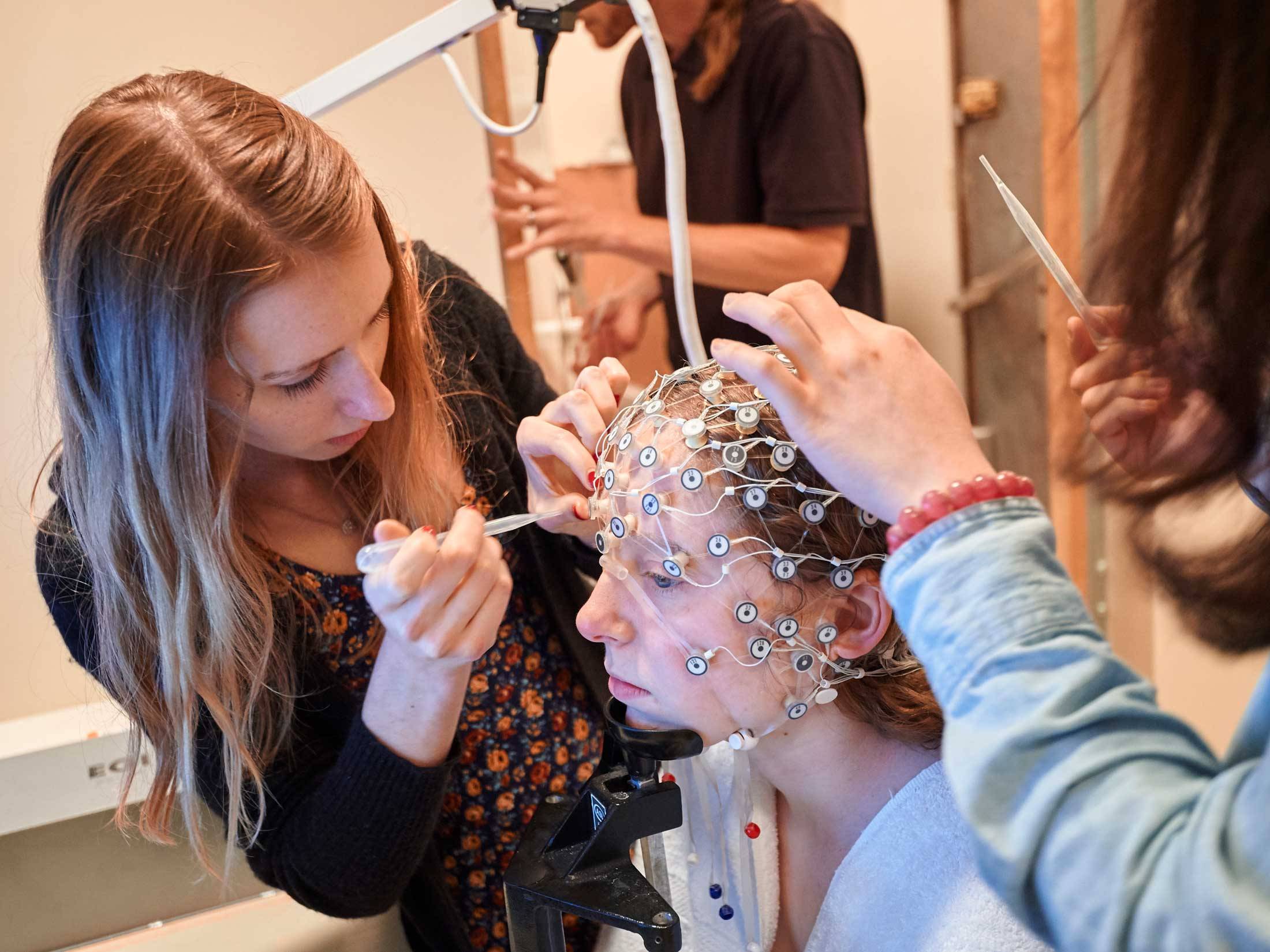 Students prepare a test subject for a brain scan