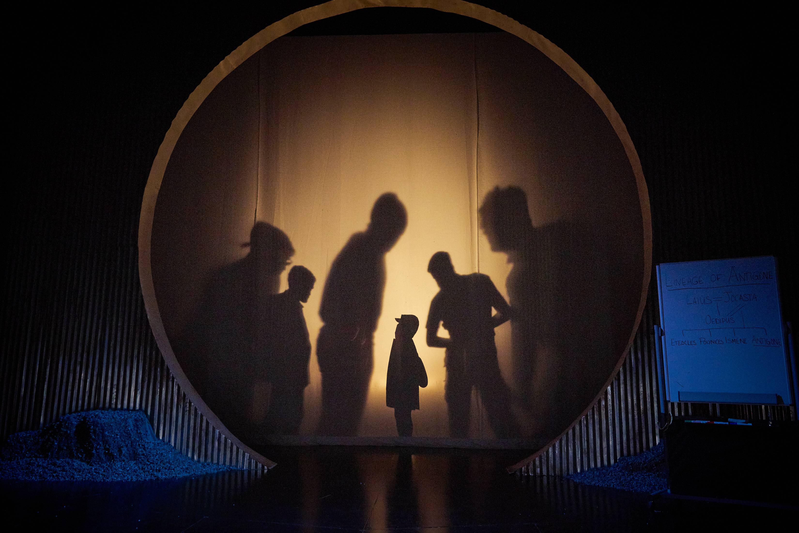 Silhouettes of characters from Antigone