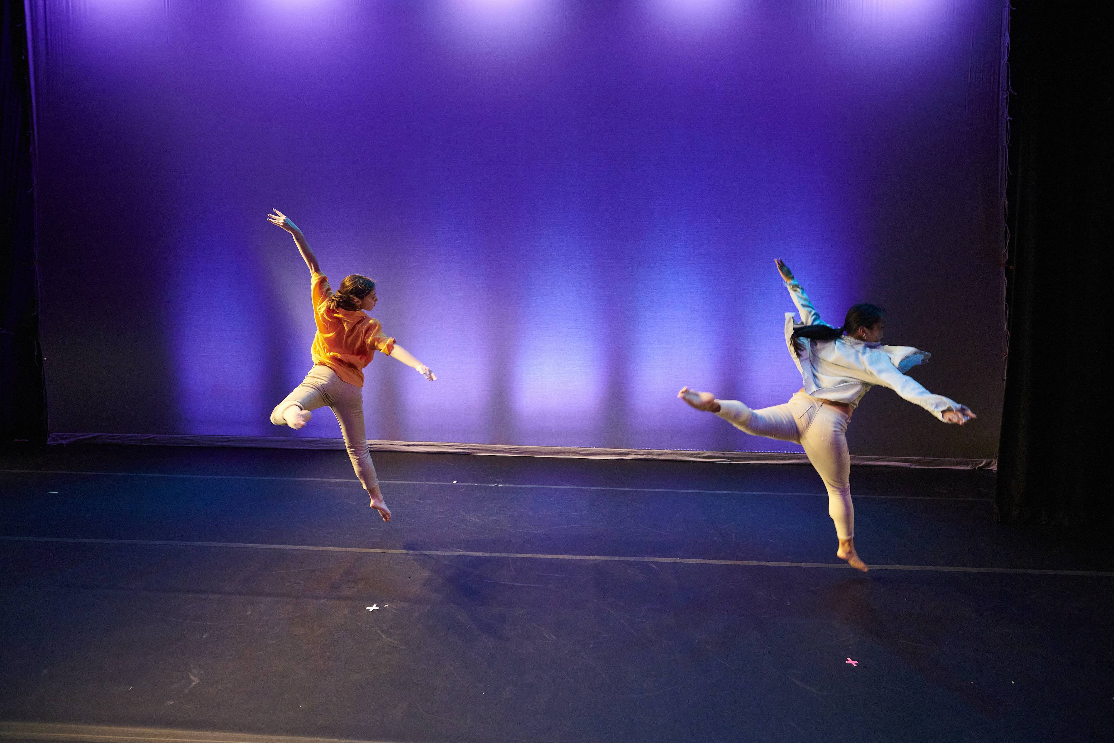 Students dancing on stage as part of the Spring 2023 Dance Concert.