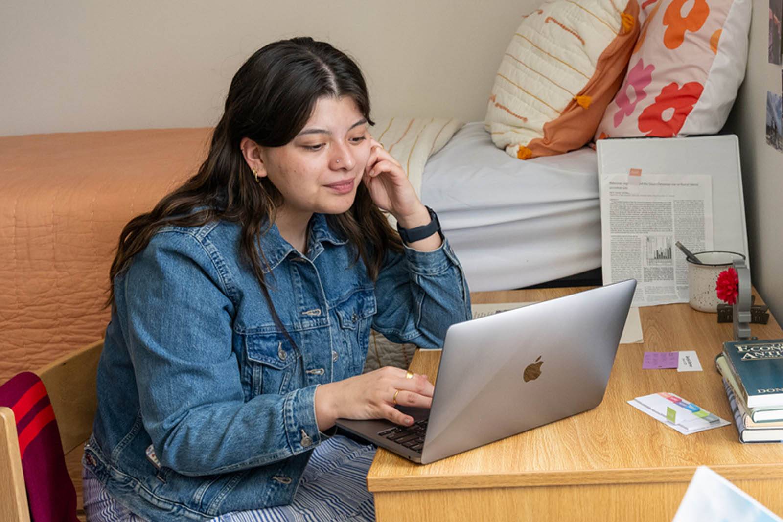 A student sits at her desk studying