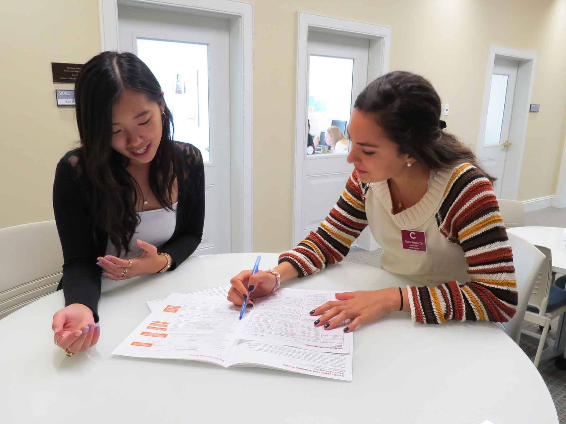 A student at a table with a peer career adviser