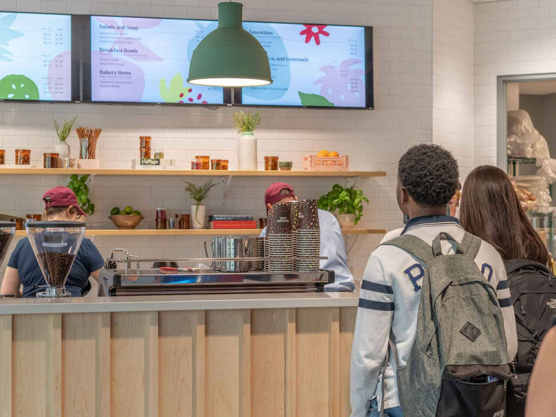 Two students at the Chobani serving counter in the HIeber Cafe in Case-Geyer Library