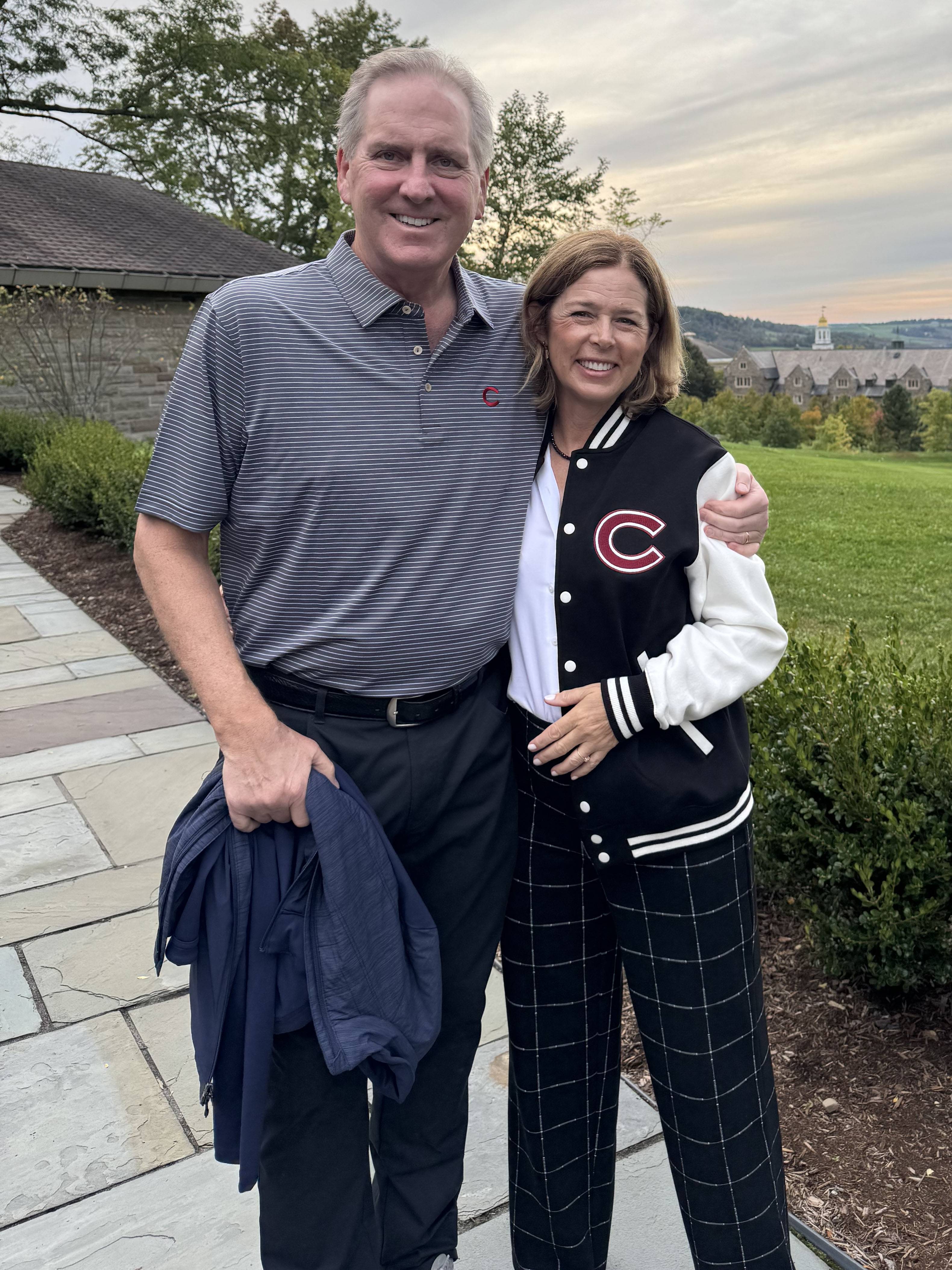 Chris and Becky Hurley, stands together on a paved walkway.