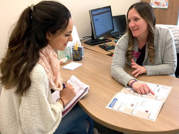 Chelsea Lehmann of Career Services counsels a student