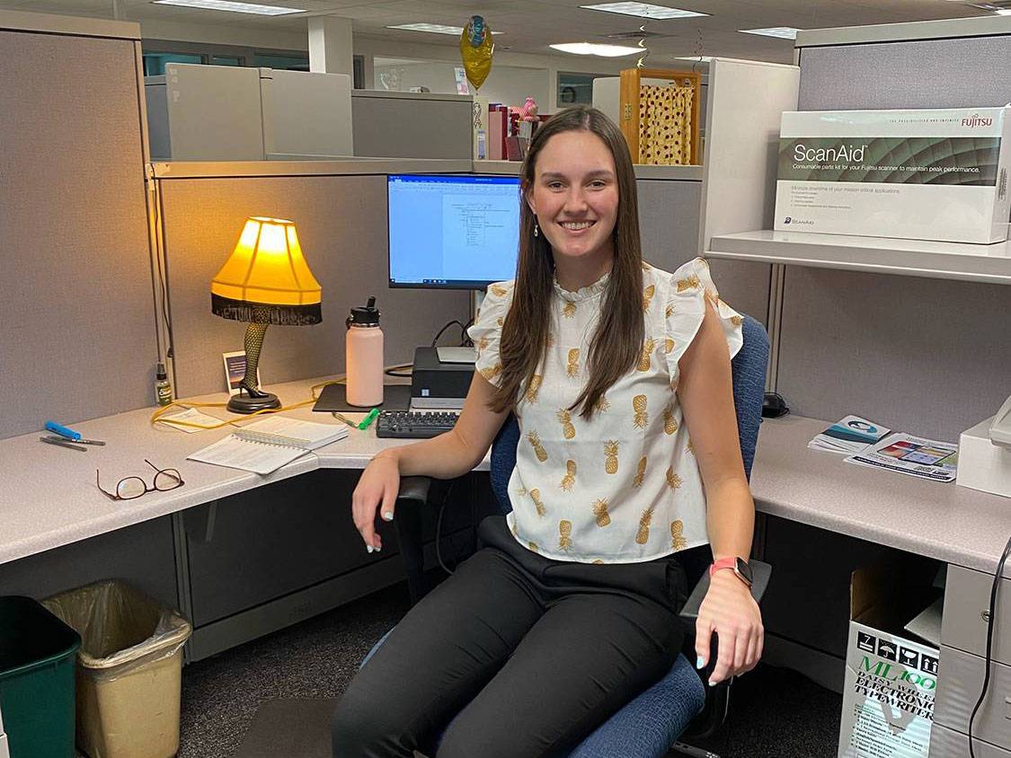 Sophia Diehl at a desk at the Madison County Public Health office