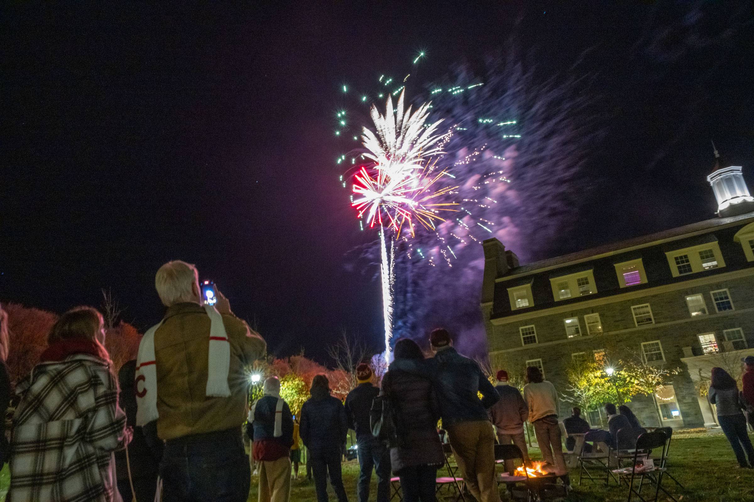 Family members watch fireworks on the Burke-Pinchin quad