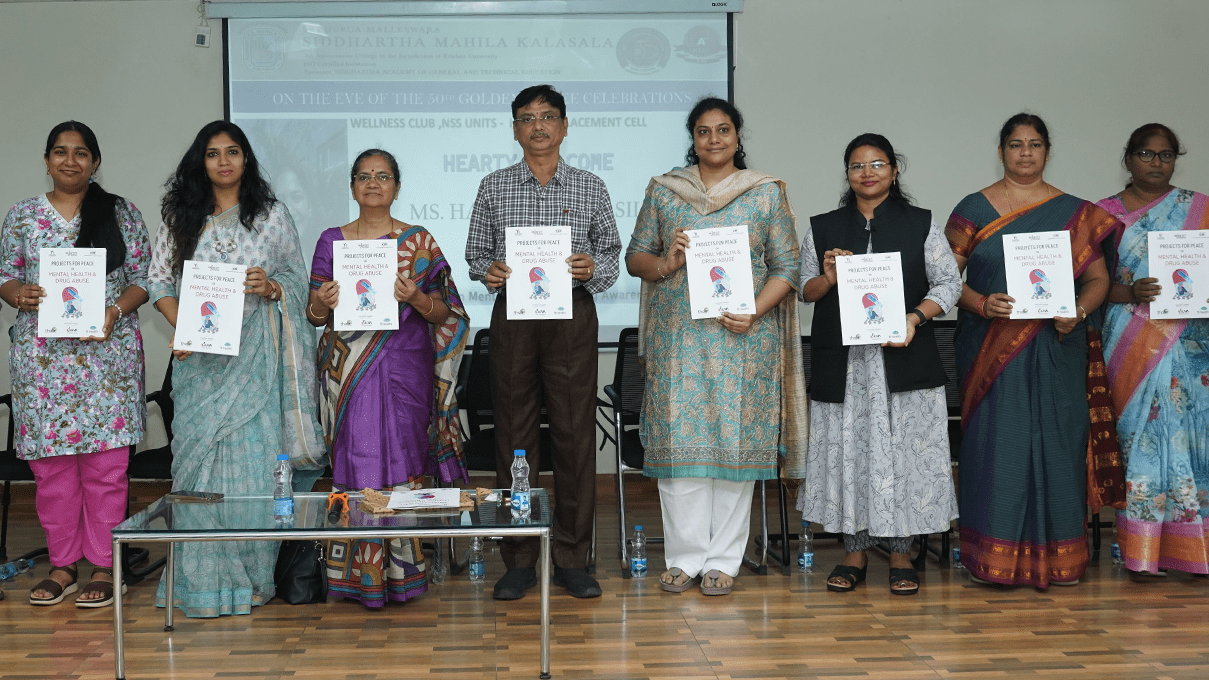 Harshitha and members of the staff at the all women’s college in Vijayawada, India stand holding print materials from the first session.
