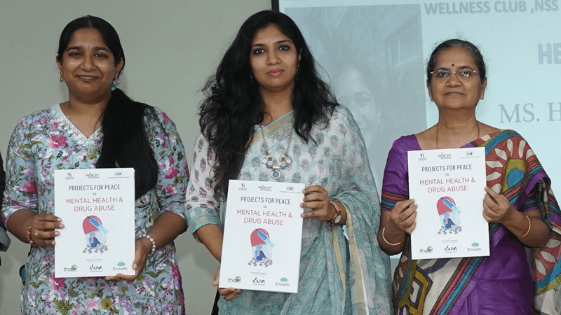 Harshitha and two members of the staff of the all women’s college in Vijayawada, India stand holding print materials from the first session.