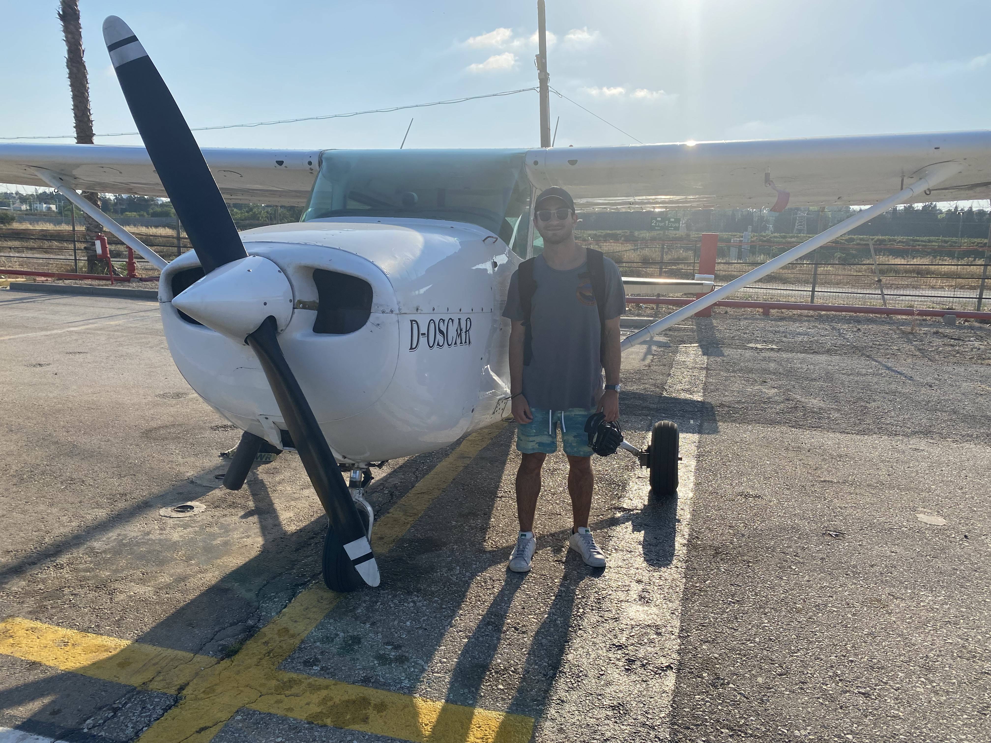 Jack Breitowich ’23 stands next to single-engine airplane