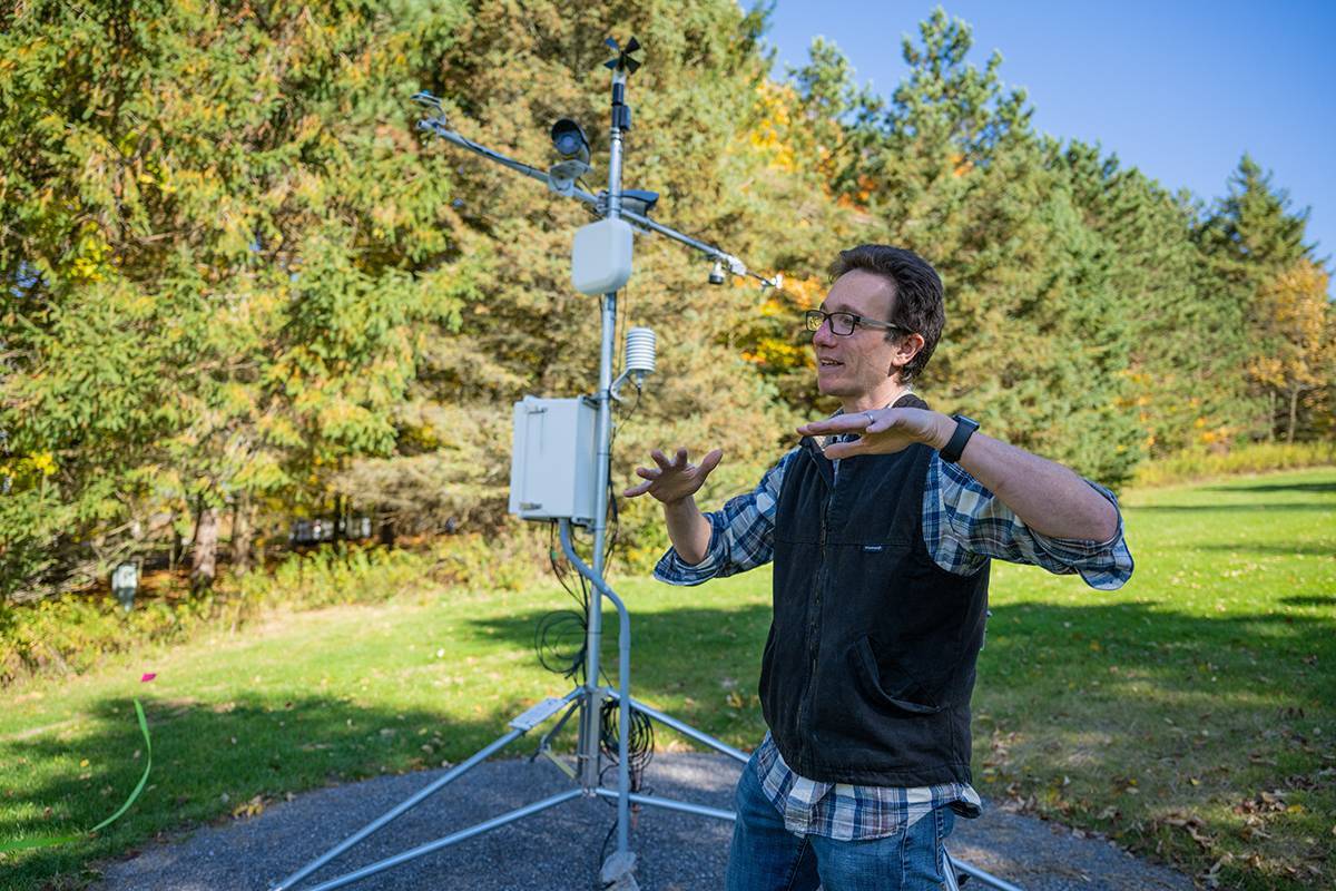 Joe Levy lectures outdoors near a weather instrument