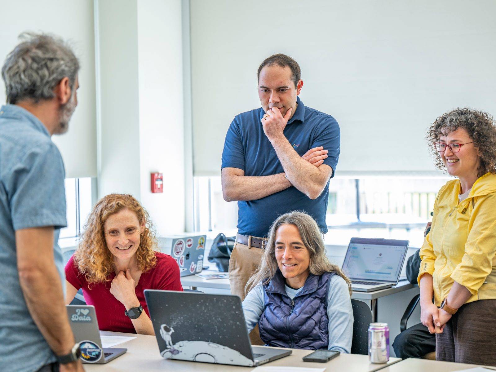 Professor Noah Apthorpe helps faculty during a session of an AI workshop in June 2026.
