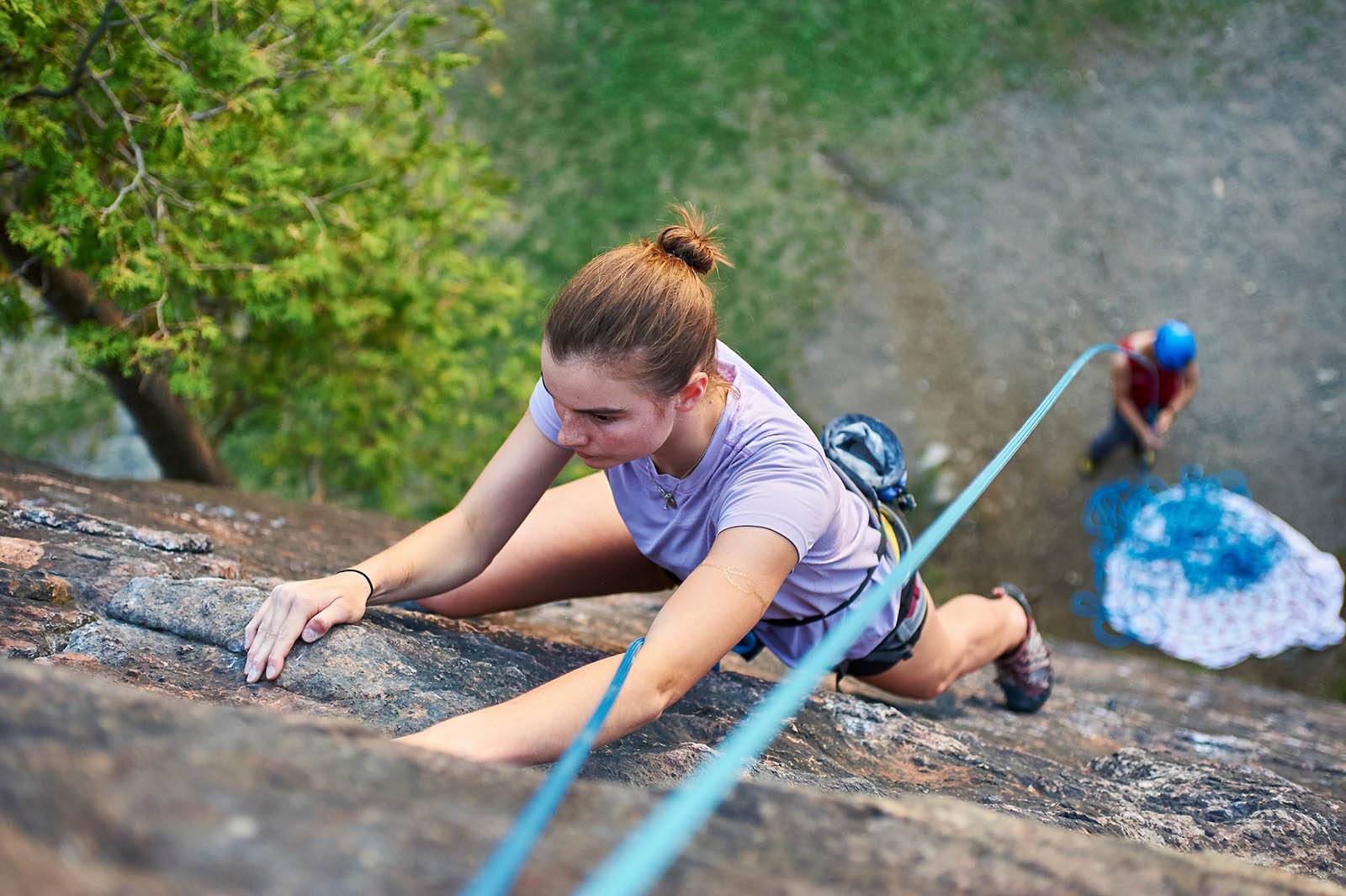 A student rock climbing
