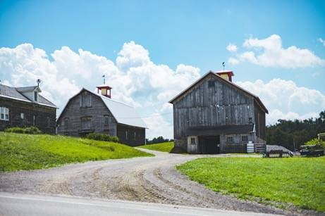 A barn and farm outbuildings on a hill