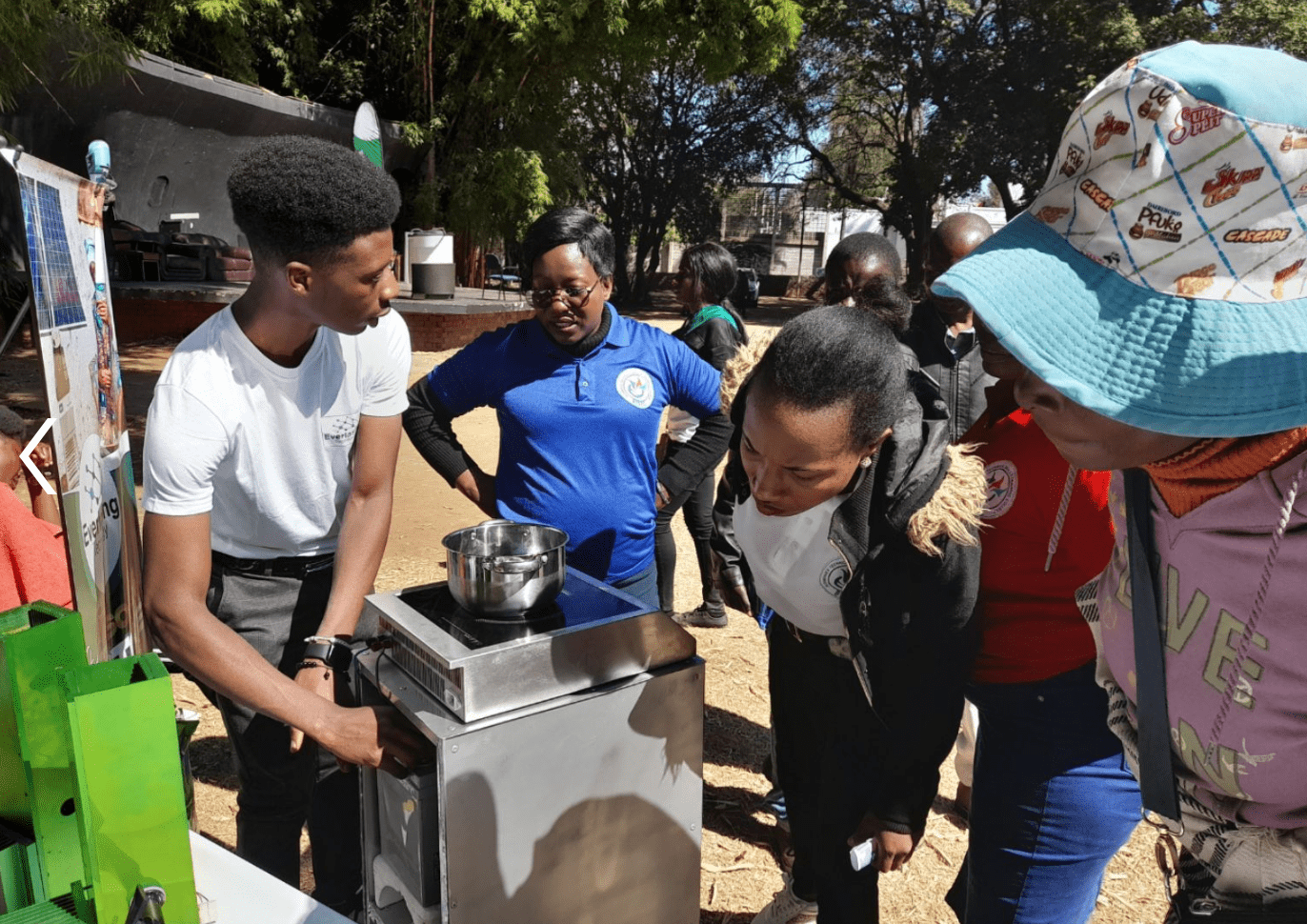 people surrounding an ecostove