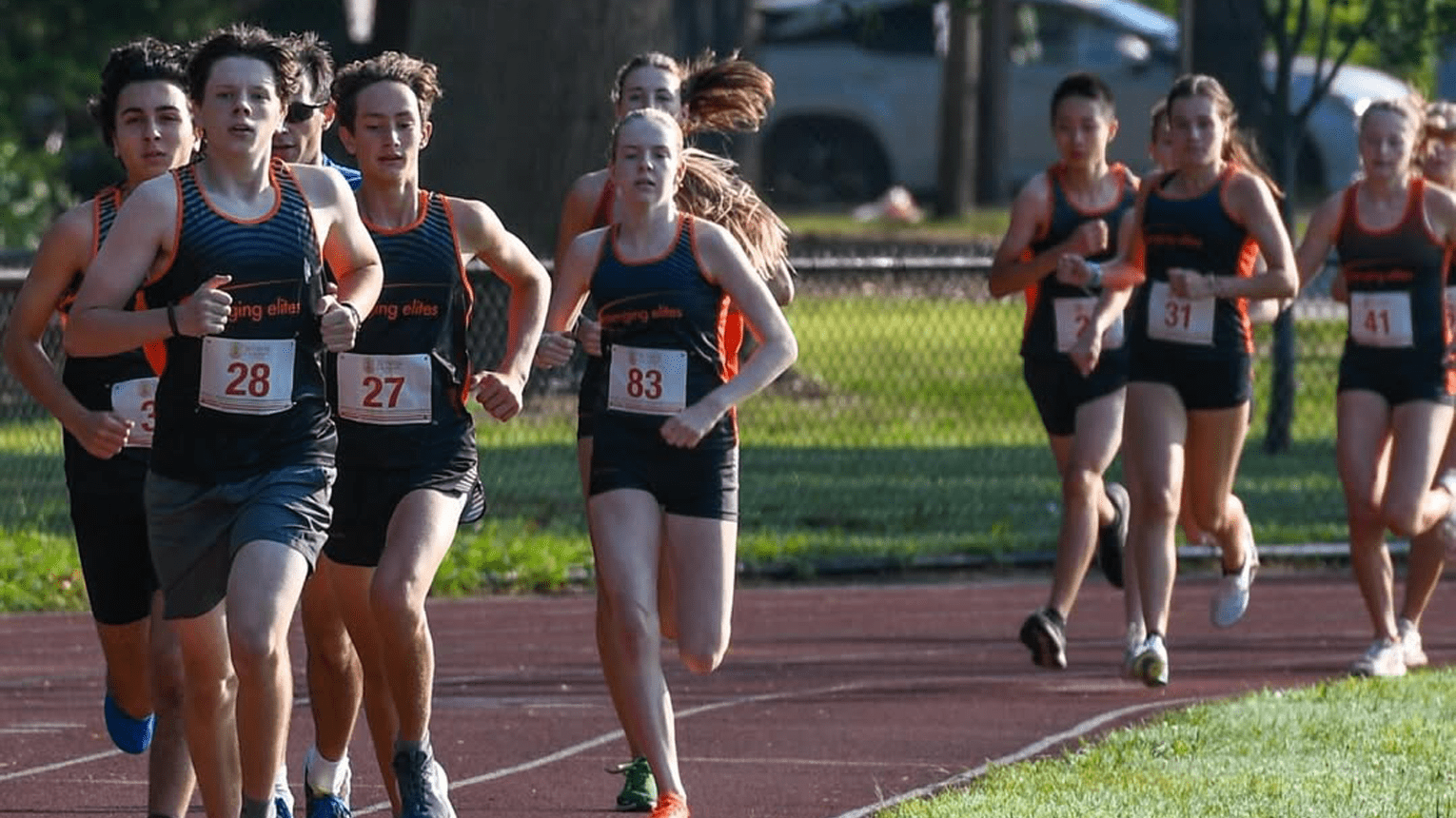 Runners moving along a track