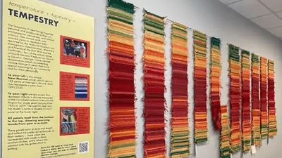 A textile tempestry showing fiber as data visualization, depicting annual deviation-from-average-temperature from the late 1800s to the present.